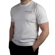Male model wearing the Billionaire by ORVELLA white luxury T-shirt with subtle chest branding, clean structured fit, and refined everyday styling.