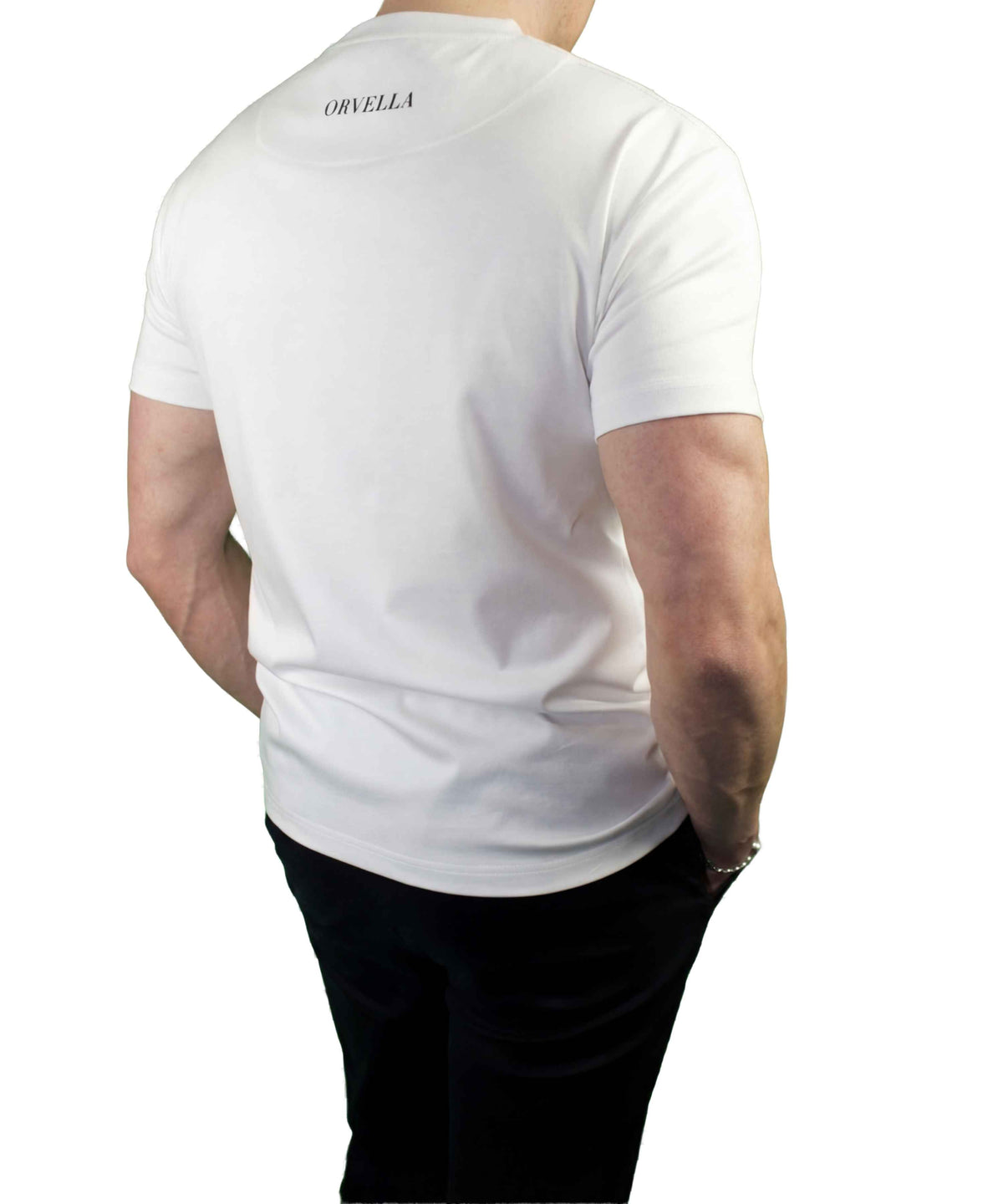 Rear view of a male model wearing the Billionaire by ORVELLA white luxury T-shirt, featuring subtle ORVELLA back neck branding and a clean structured fit.