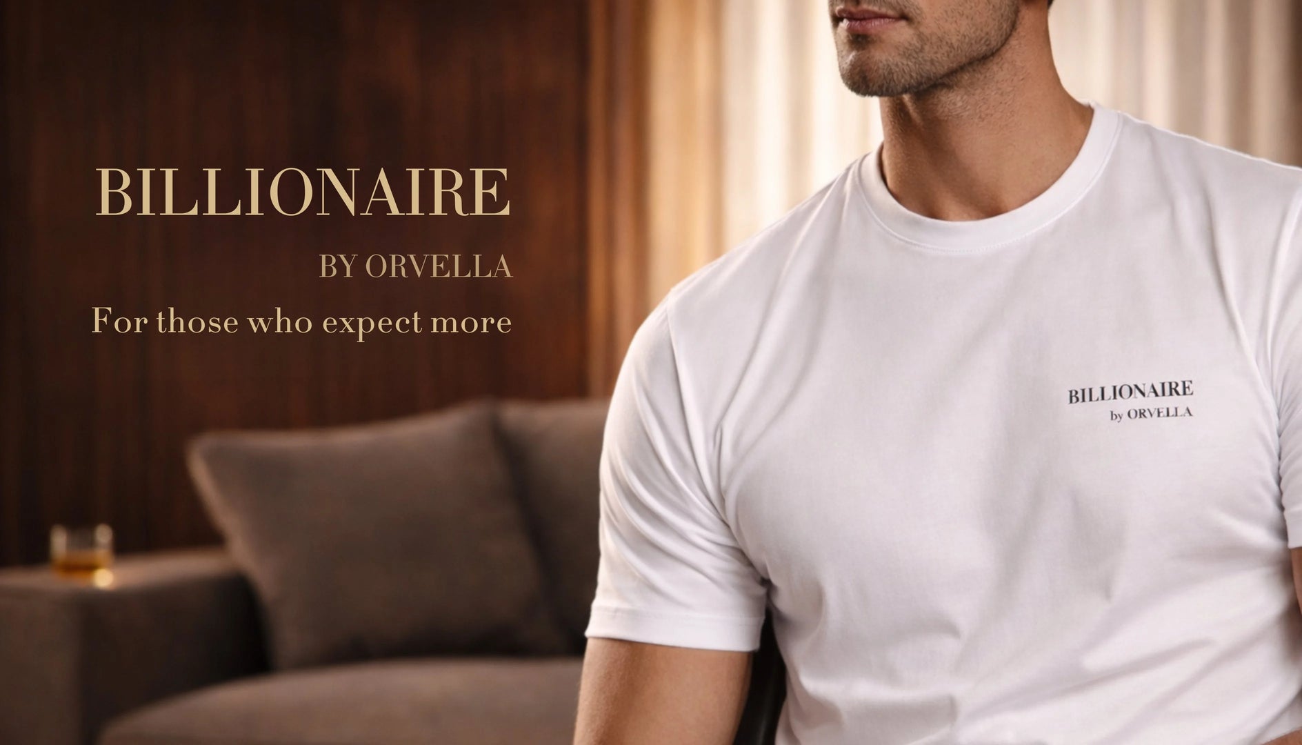Luxury white Billionaire by ORVELLA T-shirt on male model with premium branding and elegant interior backdrop