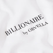Close-up of the Billionaire by ORVELLA white luxury T-shirt chest print, showing refined black branding on smooth premium fabric.