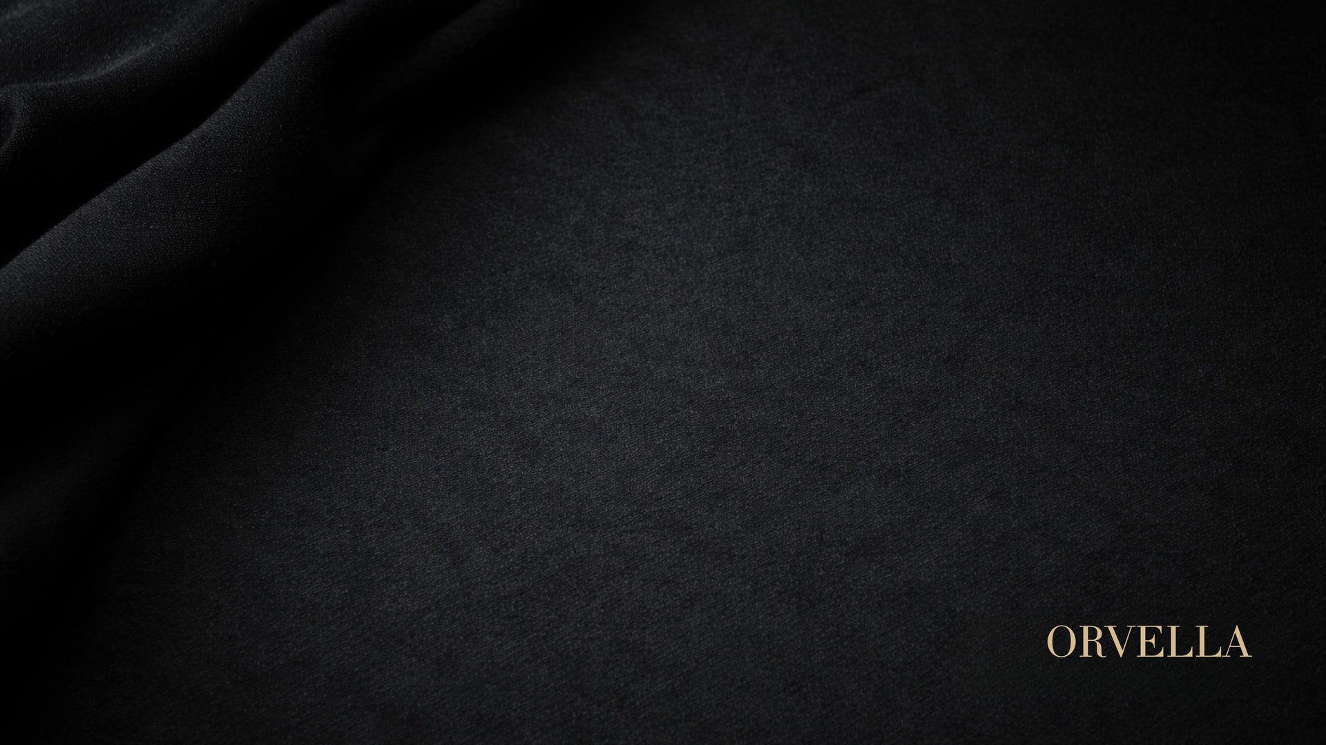 Black velvet image with ORVELLA written in gold on it