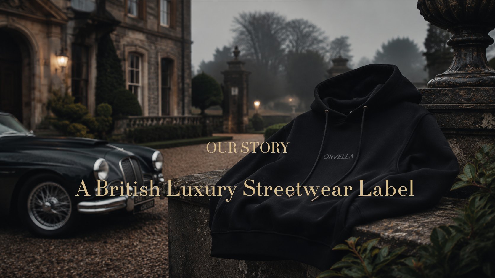 ORVELLA® Our Story banner featuring a black luxury hoodie styled against a British heritage estate backdrop with vintage car and refined editorial mood.