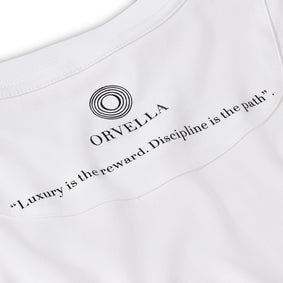 Close-up of the ORVELLA white luxury T-shirt inner neck print, showing the signature logo, clean collar stitching, soft fabric texture, and the quote “Luxury is the reward. Discipline is the path.”