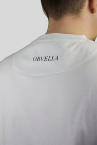 Close-up rear view of the Billionaire by ORVELLA white luxury T-shirt, showing subtle ORVELLA back neck branding, clean stitching, and refined fabric detail.