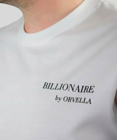Close-up of the Billionaire by ORVELLA white luxury T-shirt, showing subtle chest branding, smooth fabric texture, and refined premium streetwear detail.